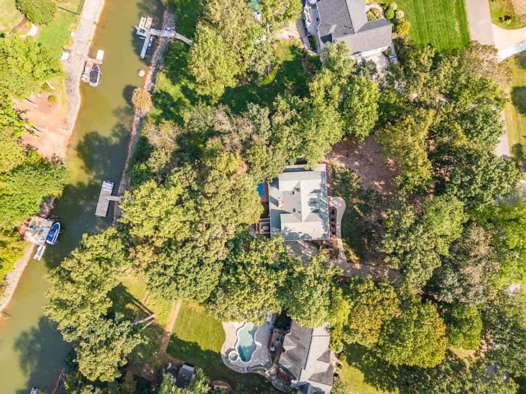 Real Estate Photography a house surrounded by trees and a body of water