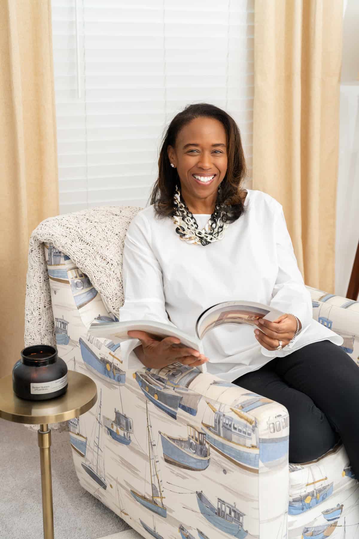 a woman sitting in a chair reading a book